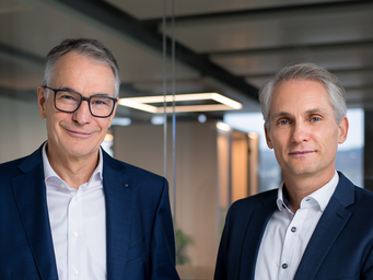 Photo of former CEO Martin Becker and new CEO Alexander Heizler standing together. 