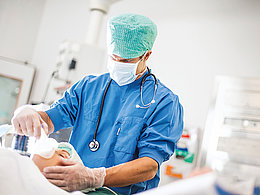 An anesthesiologist checks the patient's anesthesia status